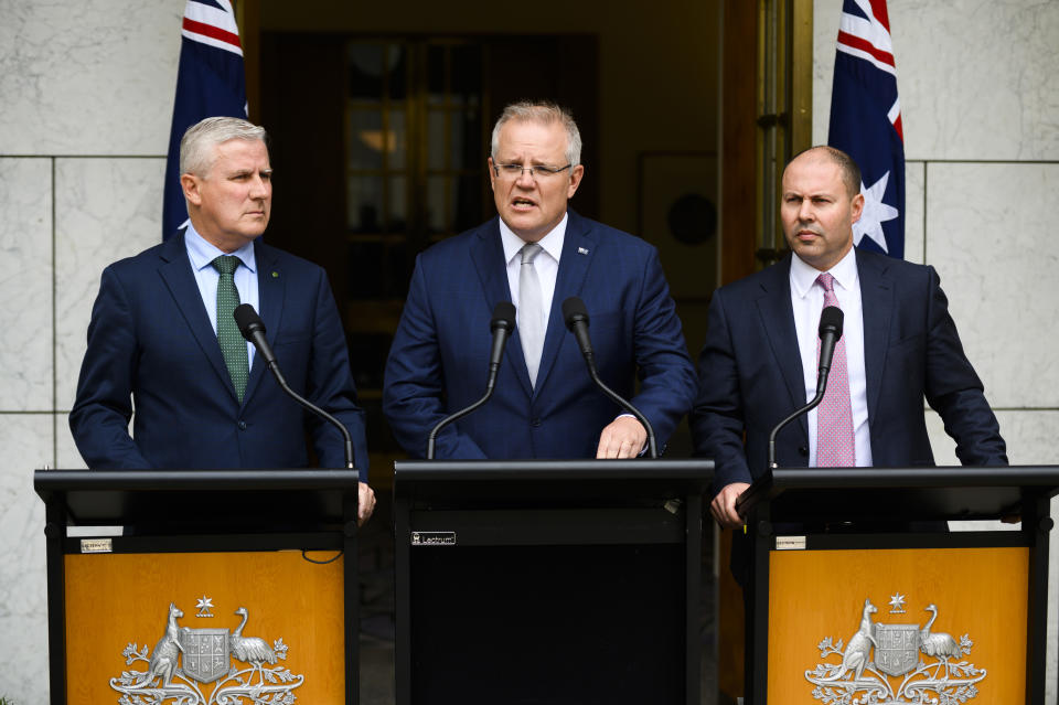 CANBERRA, AUSTRALIA - JANUARY 06: Prime Minister Scott Morrison speaks alongside Deputy Prime Minister Michael McCormack and Treasurer Josh Frydenberg at Parliament House on January 06, 2020 in Canberra, Australia. One person has died in Batlow and four firefighters were injured in NSW overnight. 14 people have now died in the fires in NSW, Victoria and South Australia since New Year's Eve. Prime Minister Scott Morrison on Saturday announced army reservists were being called up to help with firefighting efforts across Australia, along with extra Defence ships and helicopters. The Prime Minister has faced ongoing criticism over his handling of the ongoing bushfire crisis, most recently over the Liberal Party's release of advertising detailing the Government's bushfire response. (Photo by Rohan Thomson/Getty Images)