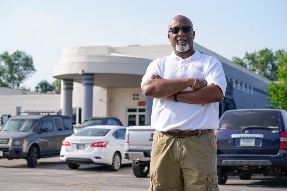 David Greene, pastor at Purpose of Life Ministries stands in parking spots outside the church which he hopes will be chosen to become electric vehicle charging spaces on Wednesday, June 22, 2022, at Purpose of Life Ministries in Indianapolis. He said they are a prime location, right of I-65 seen in the background, and it would be a positive step for the surrounding community. Greene worries however that Black and low-income communities will be left behind in the EV transition.