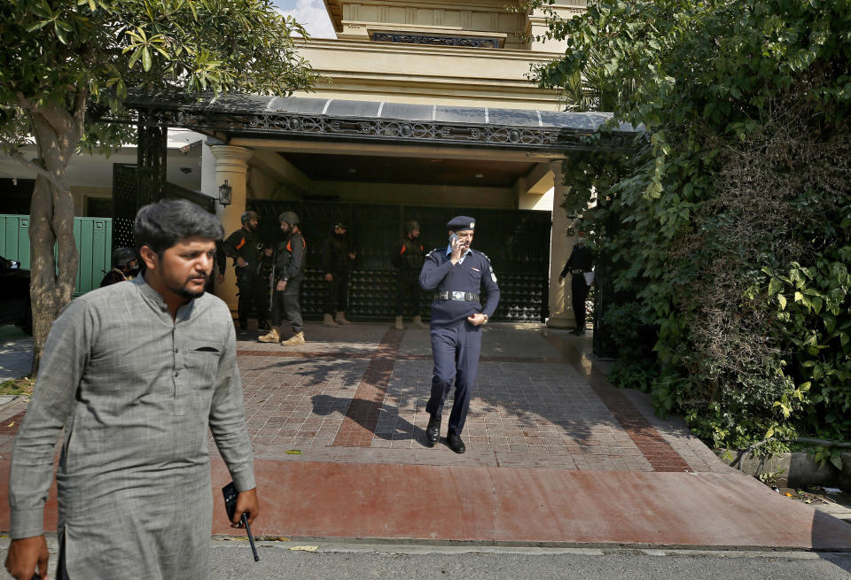 Police officers leave after searching the house of Pakistani journalist Mohsin Baig, in Islamabad, Pakistan, Wednesday, Feb. 16, 2022. Police arrested Baig, a prominent journalist and government critic, at his home on unspecified charges on Wednesday, his colleagues and local media said. (AP Photo/Anjum Naveed)