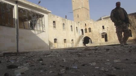 A Free Syrian Fighter is seen after shelling at the Grand Umayyad mosque at Marat al-Numan near the northern province of Idlib November 5, 2012. Picture taken November 5, 2012. REUTERS/Zakwan Hadeed/Shaam News Network/Handout