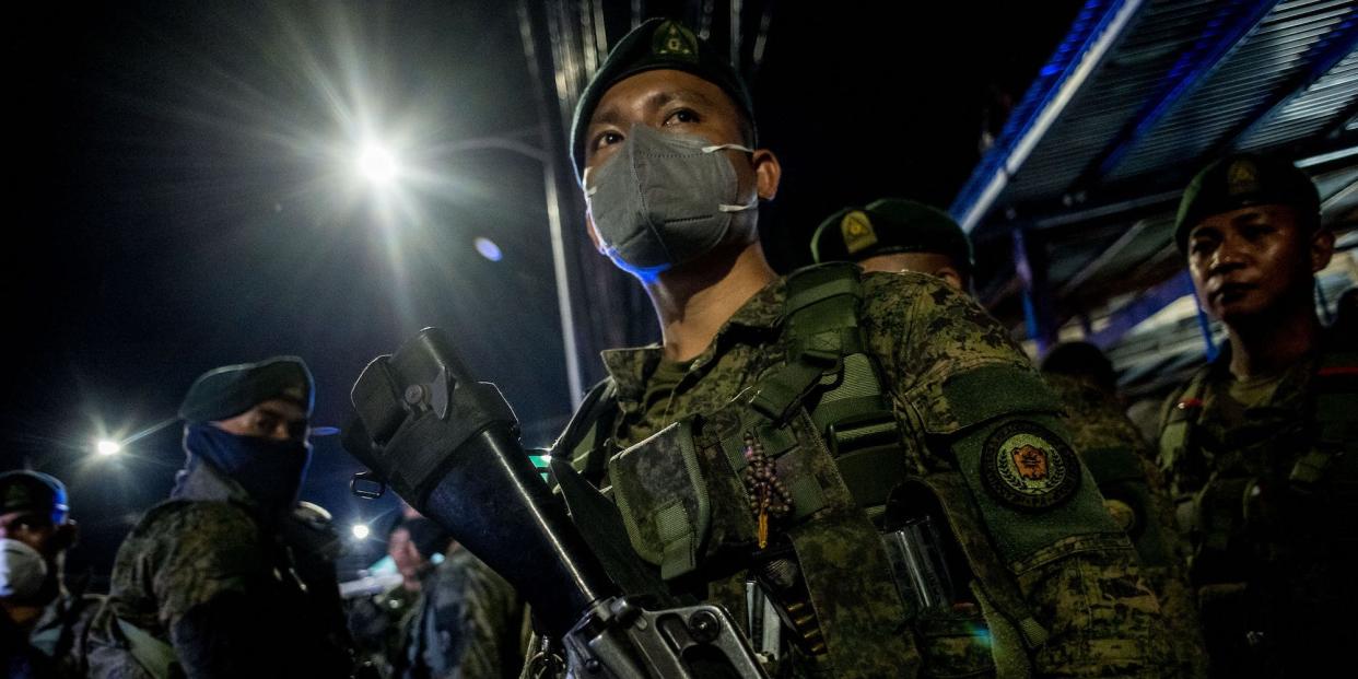 Soldiers stay at a checkpoint in the Philippines at midnight in March.