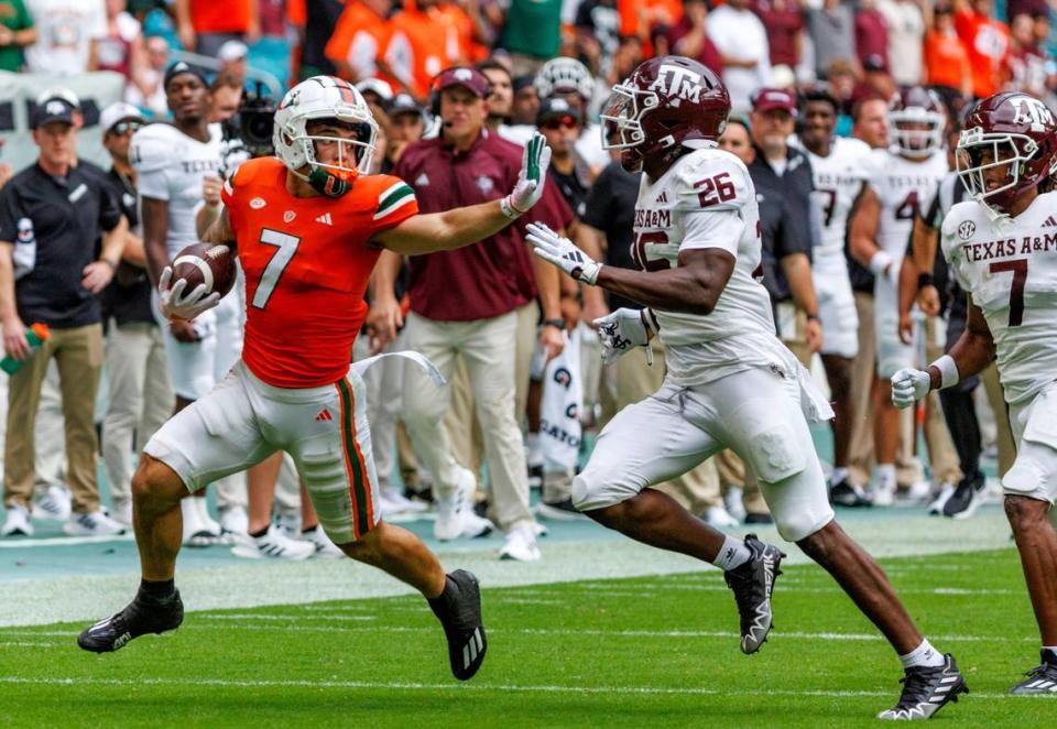 Miami Hurricanes wide receiver Xavier Restrepo (7) runs as Texas A&M Aggies defensive back Demani Richardson (26) defends during the first quarter of an NCAA non conference game at Hard Rock Stadium on Saturday, Sept. 9, 2023 in Miami Gardens, Florida.
