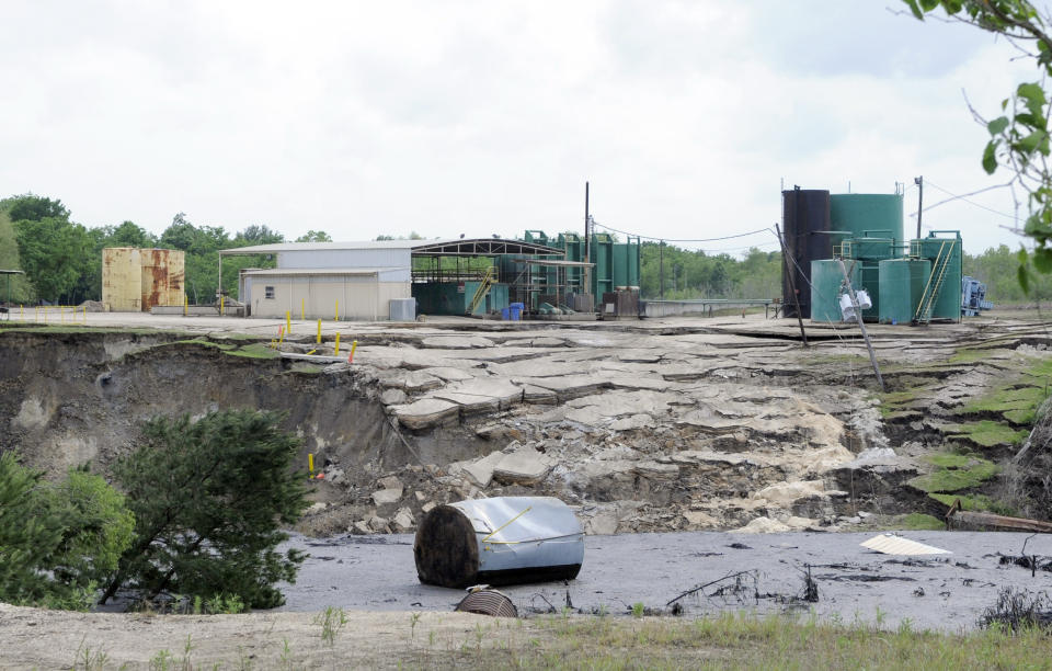 FILE - A water tank floats at the bottom of a sinkhole as it continues to grow on May 7, 2008, in Daisetta, Texas. Earlier this month, Daisetta officials announced the sinkhole, which had first emerged in 2008 but had been dormant since then, had started to again expand. Officials say they're monitoring the new growth and keeping residents informed. (AP Photo/Pat Sullivan, File)