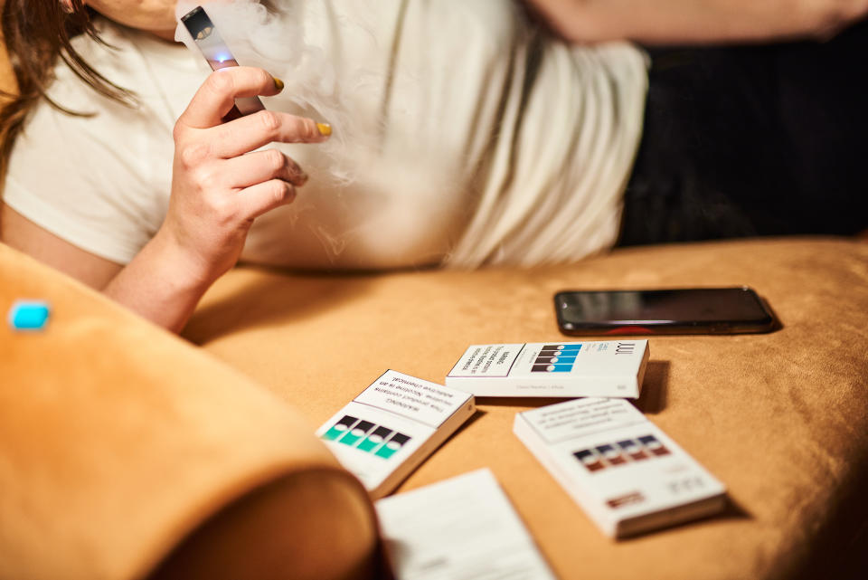 A person smokes a Juul Labs Inc. e-cigarette in this arranged photograph taken in the Brooklyn Borough of New York, U.S., on Thursday, Dec. 20, 2018. Altria Group's plan to take a $12.8 billion stake in Juul Labs could be destroying value, Citigroup analysts write in a note downgrading the stock to a sell from neutral. Photographer: Gabby Jones/Bloomberg via Getty Images