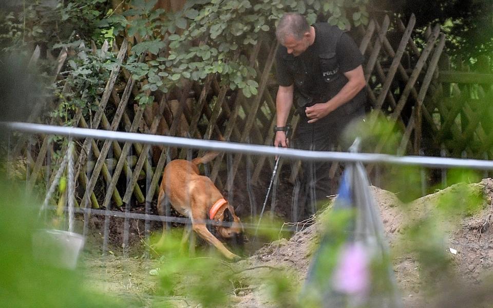 Police use sniffer dogs at the site  - AP