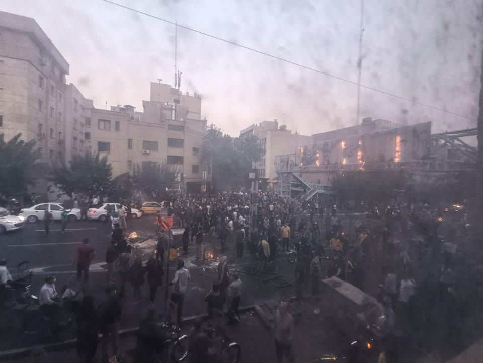 <b>Tehran, Iran </b>People gather during a protest for Mahsa Amini, who died after being arrested by morality police allegedly not complying with strict dress code in Tehran, Iran on September 20, 2022. Protests spread to 15 cities across Iran overnight over the death of the young woman Mahsa Amini after her arrest by the country’s morality police. In the fifth night of street rallies, police used tear gas and made arrests to disperse crowds of up to 1,000 people, the official IRNA news agency said.<span class="copyright">Middle East Images/Redux</span>