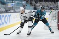 Los Angeles Kings right wing Dustin Brown (23) is defended by San Jose Sharks defenseman Nikolai Knyzhov (71) during the second period of an NHL hockey game Saturday, April 10, 2021, in San Jose, Calif. (AP Photo/Tony Avelar)