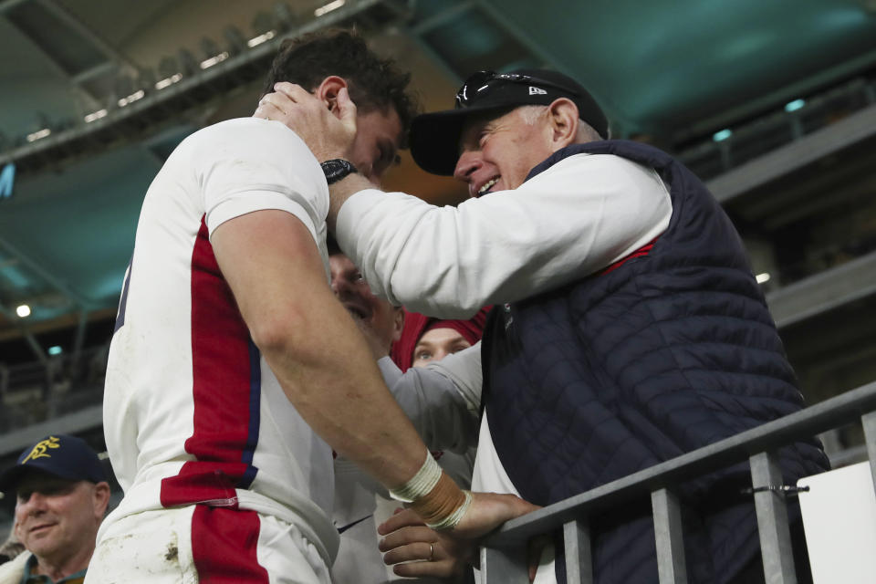 England's Henry Arundell, left, is congratulated by a fan following the rugby international between England and the Wallabies in Perth, Australia, Saturday, July 2, 2022. (AP Photo/Gary Day)