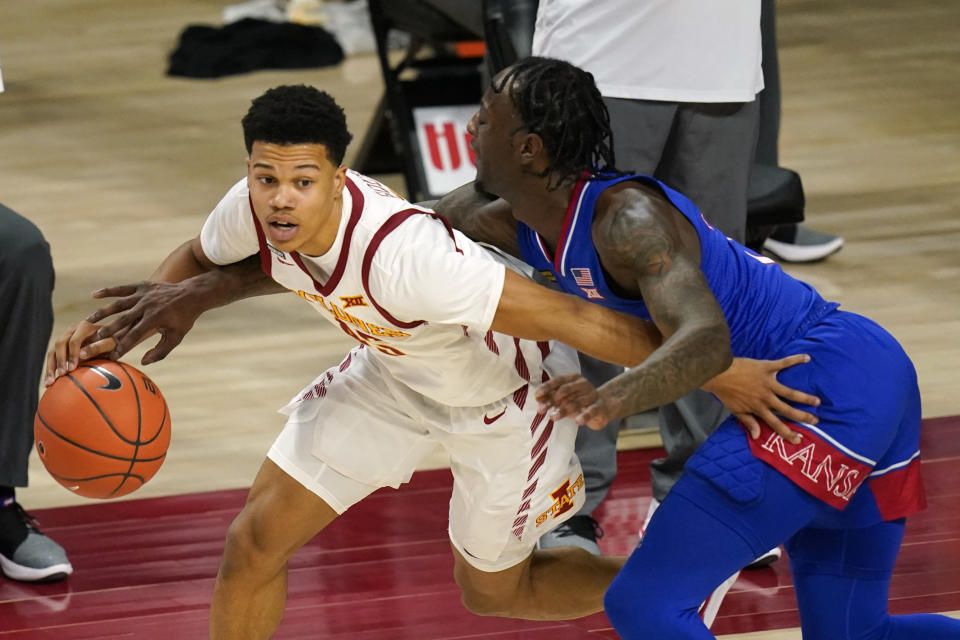 Kansas guard Marcus Garrett, right, tries to steal the ball from Iowa State guard Rasir Bolton during the second half of an NCAA college basketball game, Saturday, Feb. 13, 2021, in Ames, Iowa. Kansas won 64-50. (AP Photo/Charlie Neibergall)