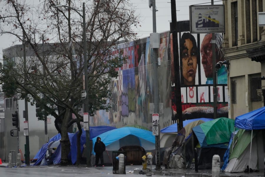 People suffering from homelessness set large tents next to the Emmanuel Baptist Rescue Mission on Monday, Feb. 5, 2024, in Los Angeles. A storm of historic proportions dumped a record amount of rain over parts of Los Angeles on Monday, sending mud and boulders down hillsides dotted with multimillion-dollar homes. In contrast, people living in homeless encampments in many parts of the city scrambled for safety. Shelters were adding beds for the city’s homeless population of nearly 75,000 people. (AP Photo/Damian Dovarganes)