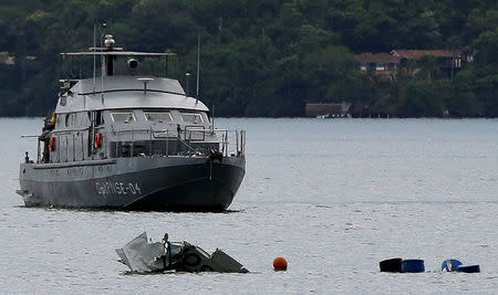 A Navy ship is seen near the wreckage from a plane, which crashed with Brazilian Supreme Court Justice Teori Zavascki, who was overseeing a graft investigation into scores of powerful politicians, in Paraty, Rio de Janeiro state, Brazil, January 20, 2017. REUTERS/Bruno Kelly