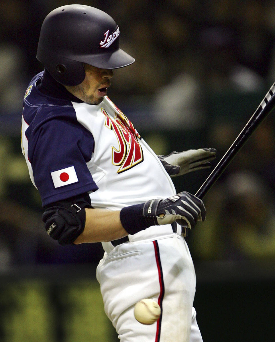 FILE - Japan's leadoff man Ichiro Suzuki of the Seattle Mariners is hit by a pitch off South Korea's Bae Yong-soo in the seventh inning of their Asia Round game of the World Baseball Classic at Tokyo Dome in Tokyo on March 5, 2006. (AP Photo/Itsuo Inouye, File)