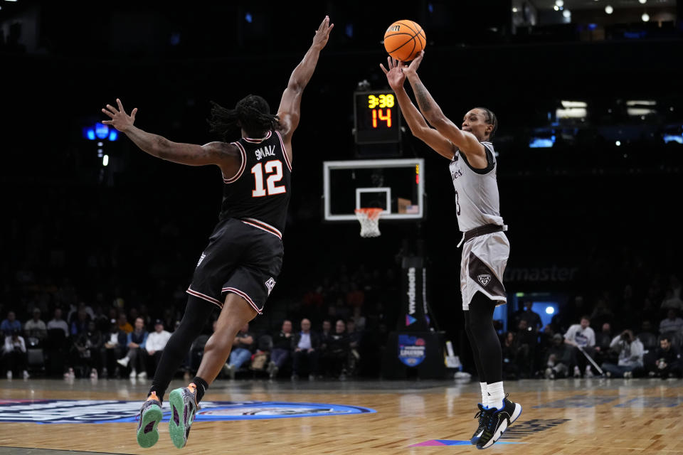 St. Bonaventure's Mika Adams-Woods (3) shoots over Oklahoma State's Javon Small (12) during the first half of an NCAA college basketball game in the Legends Classic tournament Thursday, Nov. 16, 2023, in New York. (AP Photo/Frank Franklin II)