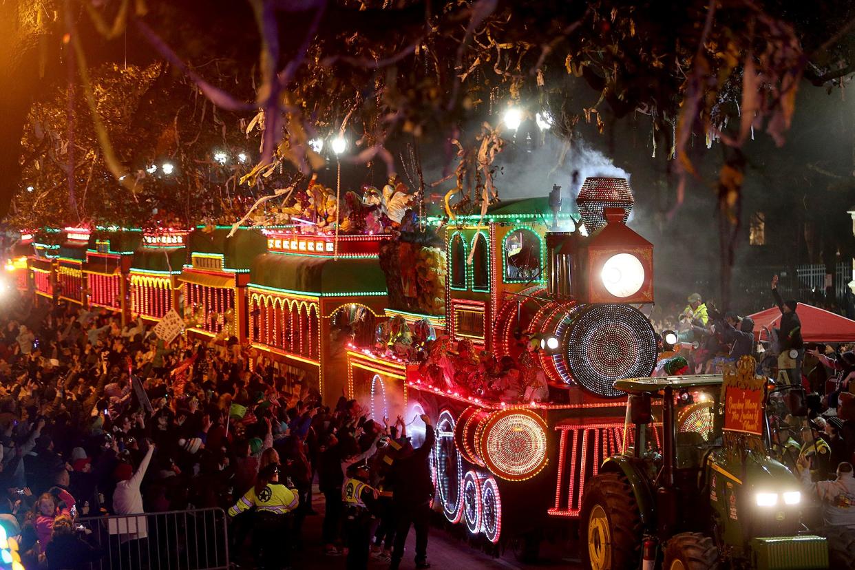 The giant train float Smokey Mary chugs down Napoleon Avenue as the 1,400 men and women of the Krewe of Orpheus present a 38-float Mardi Gras parade entitled "The Orpheus Imaginarium" on the Uptown parade route in New Orleans on Monday, March 4, 2019. (Michael DeMocker/The Times-Picayune via AP)