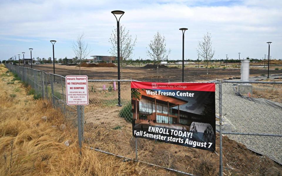A sign at Walnut and Church Avenues encourages enrollment for Fresno City College’s new west Fresno campus still under construction Thursday, June 22, 2023.
