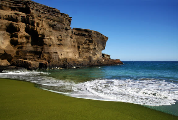 The extraordinary olive-green sands of Papakolea Beach are located near the southern tip of Hawaii's Big Island. The sand comes from small green <a href="http://www.livescience.com/3004-hawaiian-cave-reveals-ancient-secrets.html" rel="nofollow noopener" target="_blank" data-ylk="slk:volcanic s;elm:context_link;itc:0;sec:content-canvas" class="link ">volcanic s</a>