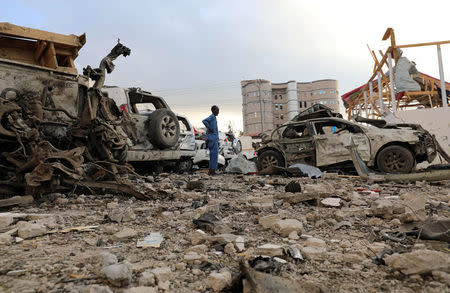 A security officer from Doorbin Hotel assesses the debris after a suicide car explosion in front of the hotel in Mogadishu, Somalia February 24, 2018. REUTERS/Feisal Omar