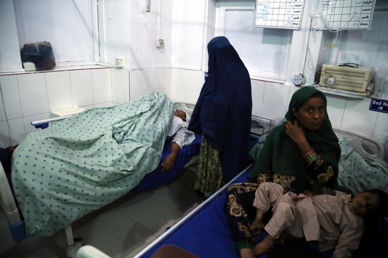 <p>An Afghan woman who was injured when unknown gunmen opened fire and killed Afghan female journalists of Enikas Radio Television Network, receives medical treatment at a hospital, in Jalalabad, Afghanistan</p> (EPA)