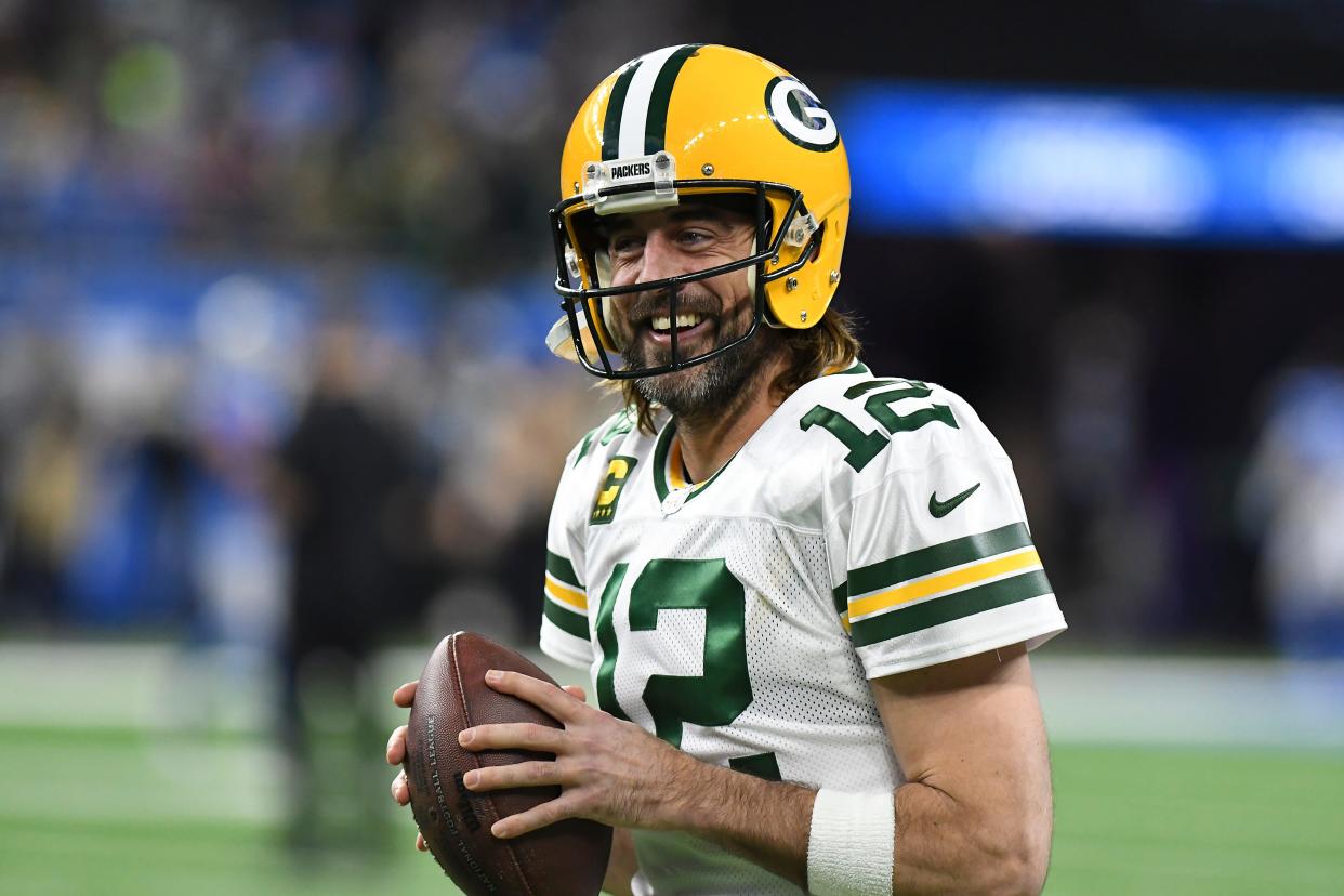 FILE - Green Bay Packers quarterback Aaron Rodgers smiles during pregame of an NFL football game against the Detroit Lions, Sunday, Jan. 9, 2022, in Detroit. Aaron Rodgers is planning to come back to the Green Bay Packers for an 18th season, a move that keeps the reigning MVP off the trade market and answers the question that had dominated NFL offseason discussions. (AP Photo/Lon Horwedel, File)