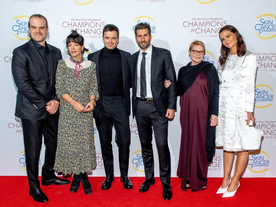 David Harbour, Lily Allen, Sebastian Stan, Adam Schweitzer, Dianne West, and Katie Holmes pose for photos on the red carpet at a 2019 gala.