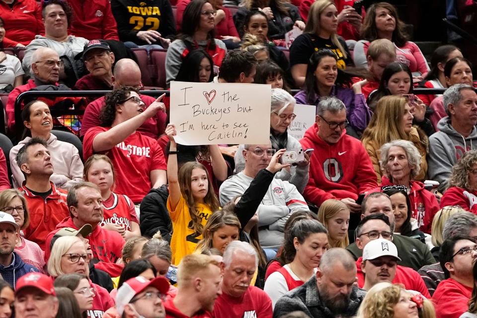 A fan holds up a sign for Iowa guard Caitlin Clark during her game against Ohio State  at Value City Arena on Sunday.