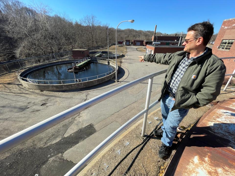 Norwich Public Utilities Chief Plant Operator David Grundwalski points  at the clarifiers at the Norwich Wastewater Treatment Plant on Hollyhock Island. Most of the plant will be replaced during a five-year project, expected to cost at least $167 million.