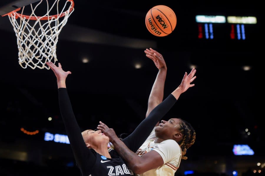 Gonzaga forward Eliza Hollingsworth, left, defends as Texas forward DeYona Gaston shoots during the first half of a Sweet 16 college basketball game in the women’s NCAA Tournament, Friday, March 29, 2024, in Portland, Ore. (AP Photo/Steve Dykes)