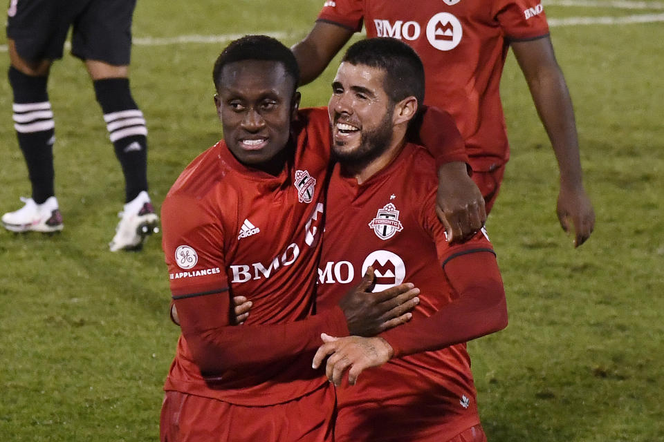 Toronto FC's Richie Laryea, left, and Toronto FC's Alejandro Pozuelo celebrates Pozuelo's goal during the second half of an MLS match against Inter Miami, Sunday, Nov. 1, 2020, in East Hartford, Conn. (AP Photo/Jessica Hill)