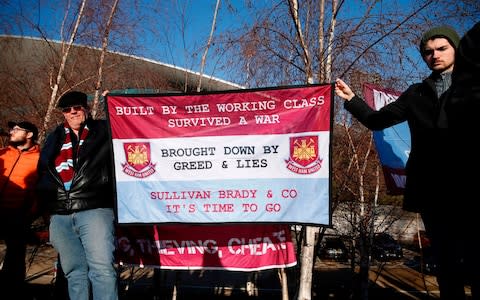 Fans demonstate against the owners of West Ham United, ahead of the English Premier League football match between West Ham United and Everton  - Credit: AFP