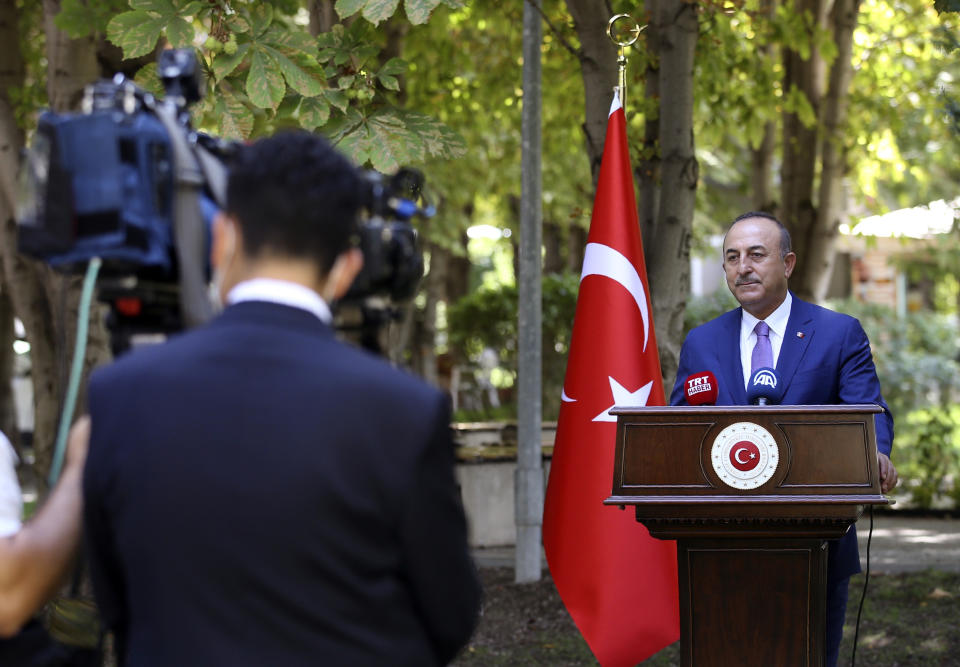 Turkey's Foreign Minister Mevlut Cavusoglu speaks to the media, in Ankara, Turkey, Friday, Sept. 4, 2020. On Thursday, NATO Secretary General Jens Stoltenberg said Turkey and Greece had agreed to start "technical talks" to reduce the risks of military "incidents and accidents." But Athens denied any such agreement, and Ankara said it backs Stoltenberg's initiative for military and technical talks and called on Greece to do the same. Cavusoglu accused Greece of "lying" over the NATO initiative. (Fatih Aktas/Turkish Foreign Ministry via AP, Pool)