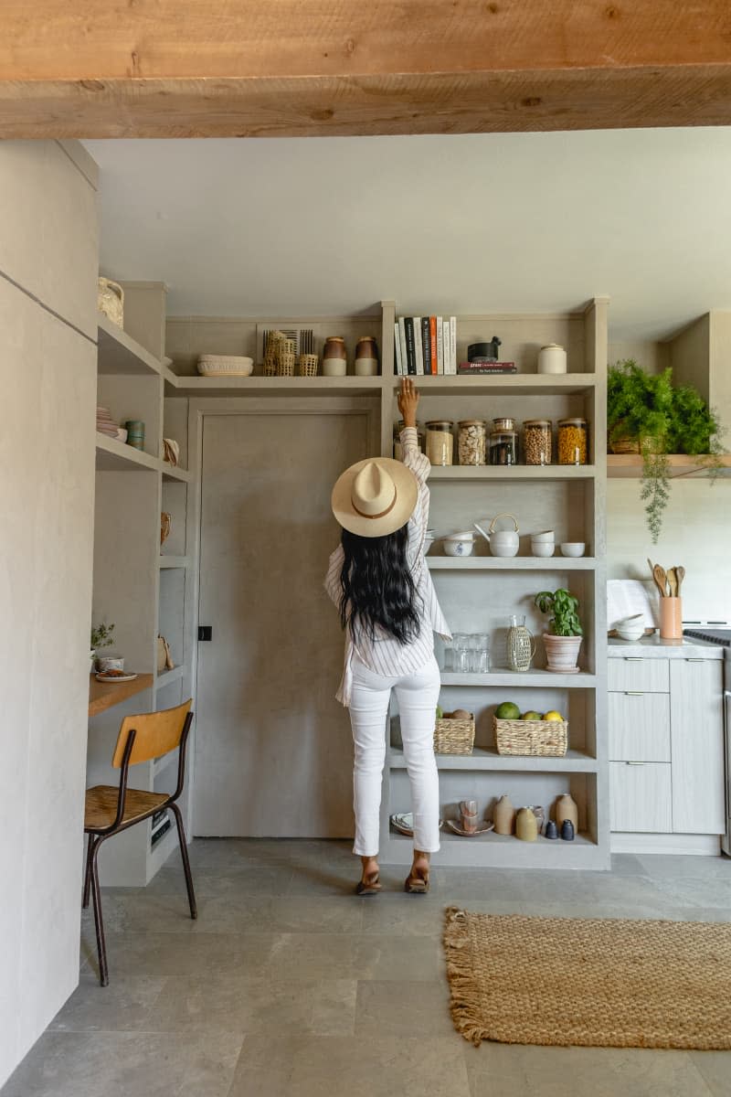 Veronica Valencia Hughes reaching for book on high shelf