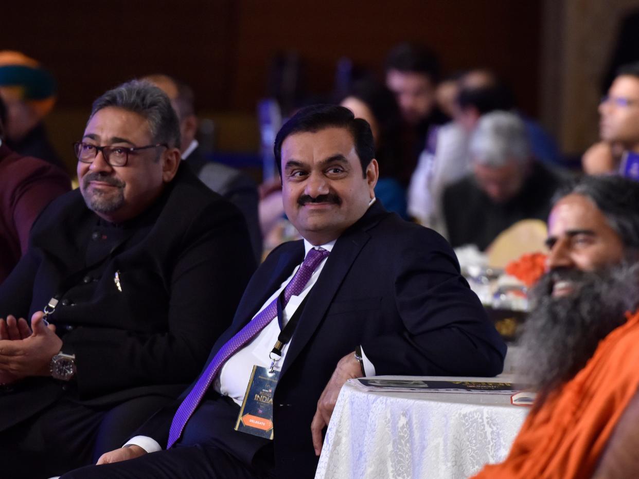 Gautam Adani sitting at a conference summit