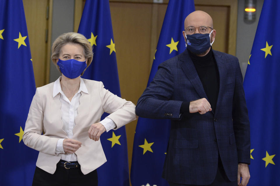 European Commission President Ursula von der Leyen, left, and European Council President Charles Michel bump elbows after signing the EU-UK Trade and Cooperation Agreement at the European Council headquarters in Brussels, Wednesday, Dec. 30, 2020. European Union's top officials have formally signed the post-Brexit trade deal sealed with the United Kingdom. European Commission president Ursula von der Leyen and European Council president Charles Michel put pen to paper on Wednesday morning during a brief ceremony in Brussels (Johanna Geron, Pool Photo via AP)