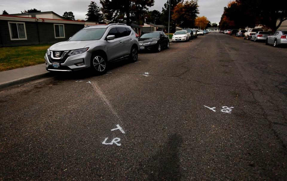 Police paint marks in the 1300 block of West Fifth Avenue in Kennewick show where Julian Chavez, 19, died in November 2022 after being shot in his car.