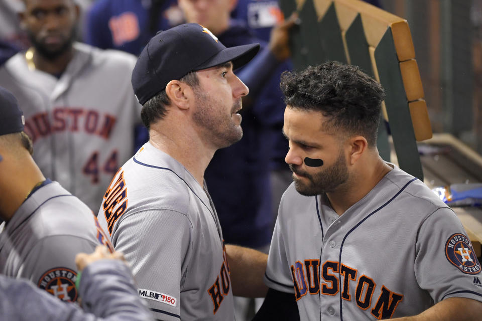 Houston Astros' Justin Verlander, left, is congratulated by Jose Altuve in the dugout after striking out Los Angeles Angels' Kole Calhoun for his 3,000th career strikeout during the fourth inning of a baseball game Saturday, Sept. 28, 2019, in Anaheim, Calif. (AP Photo/Mark J. Terrill)