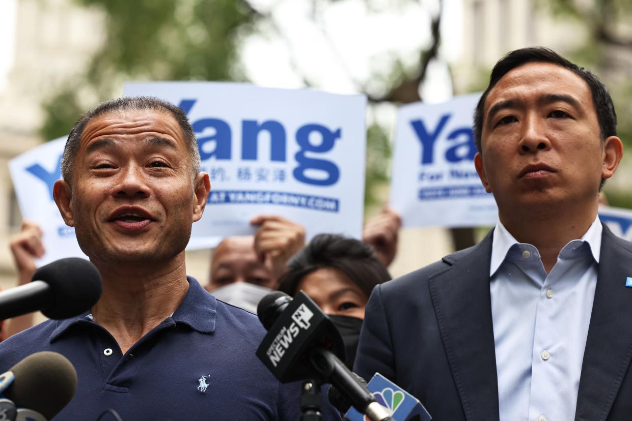 State Senator John C. Liu answers questions from reporters as he stands next to New York City Mayoral candidate Andrew Yang during a rally at City Hall Park in Manhattan on May 24, in New York City. 