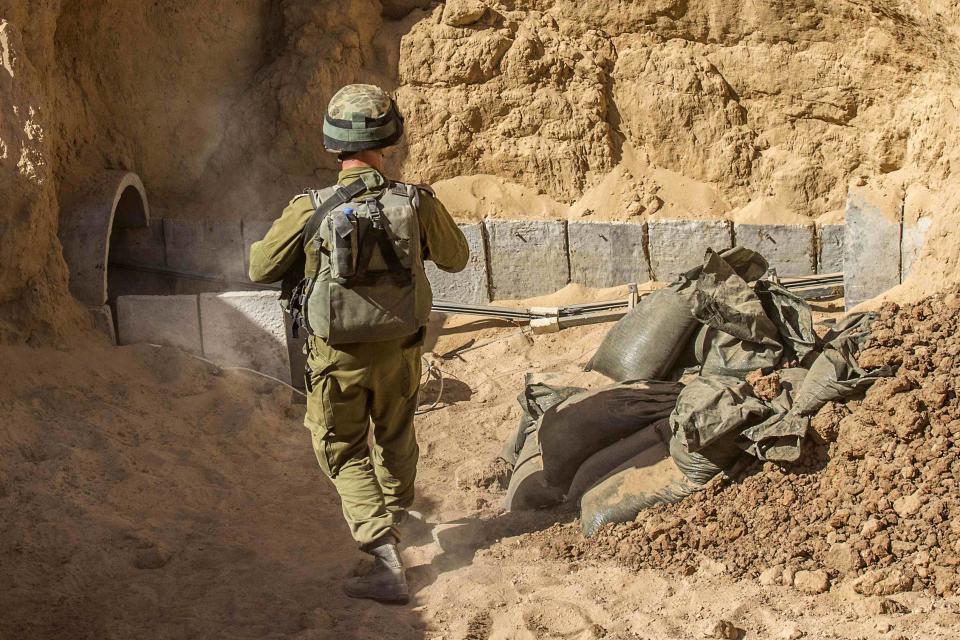 An Israeli army officer stands at the entrance of a tunnel said to be used by Palestinian militants for cross-border attacks, during an army organised tour for journalists on July 25, 2014. (REUTERS/Jack Guez/Pool)