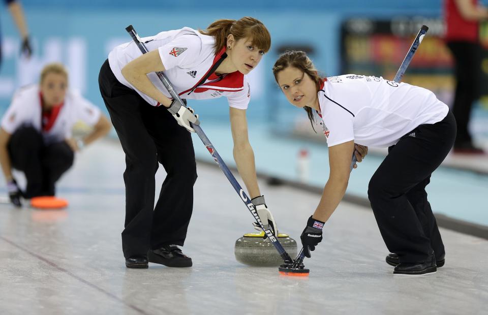 Great Britain's Claire Hamilton, right, and Anna Sloan, right, sweep the ice during the women's curling competition against Sweden at the 2014 Winter Olympics, Monday, Feb. 10, 2014, in Sochi, Russia. (AP Photo/Wong Maye-E)