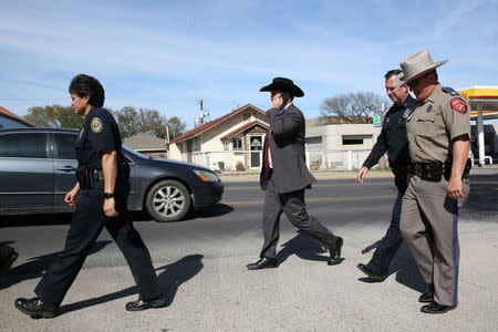 Christopher Combs (C), special agent in charge of the FBI's San Antonio division, departs a news conference in Pflugerville, Texas, U.S., March 21, 2018. REUTERS/Loren Elliott