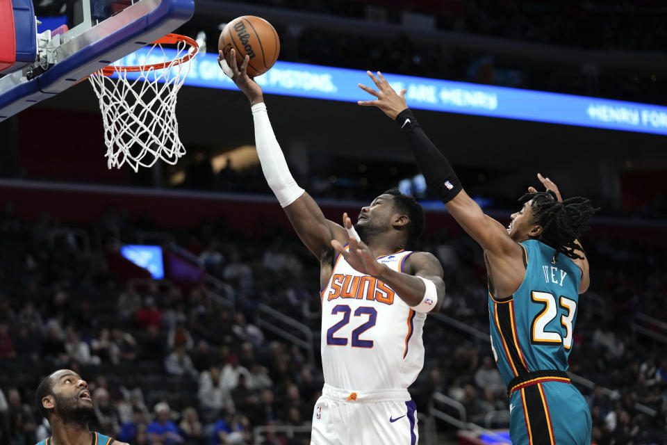 Phoenix Suns center Deandre Ayton (22) drives on Detroit Pistons guard Jaden Ivey (23) in the first half of an NBA basketball game in Detroit, Saturday, Feb. 4, 2023. (AP Photo/Paul Sancya)