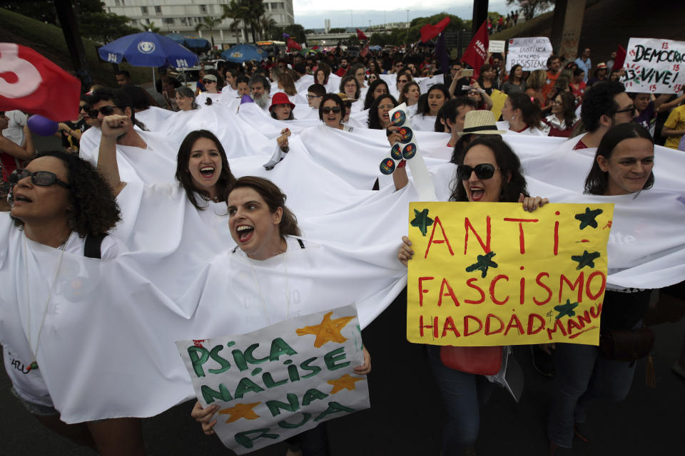 Women carry signs that read in Portuguese "Anti Fascism, Haddad Yes", during a protest called "Women against Bolsonaro," in Brasilia, Brazil, on Saturday, Oct. 20, 2018. Women and left-wing militants held protests across the country against the right-wing presidential candidate Jair Bolsonaro. (AP Photo/Eraldo Peres)