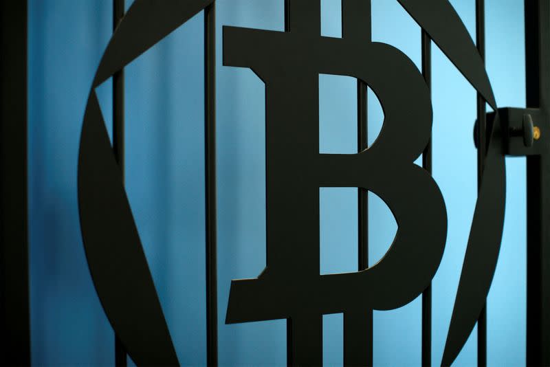 FILE PHOTO: The bitcoin logo is pictured on a door in an illustration picture taken at La Maison du Bitcoin in Paris