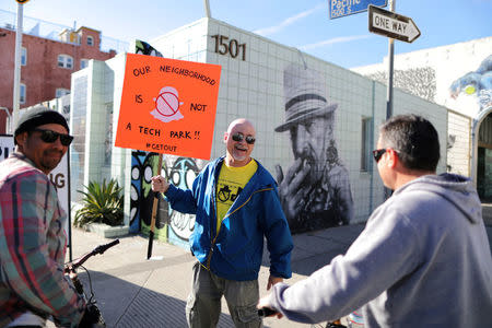 Bradford Ekhart, 53, (C) greets fellow protesters outside a Snap Inc. office in Venice, a beach community of Los Angeles, California, U.S., March 2, 2017. REUTERS/Lucy Nicholson