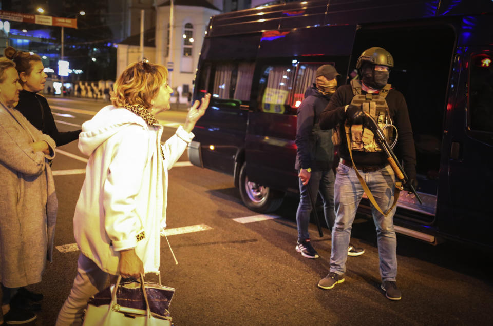 Women argue with riot police during an opposition rally to protest the presidential inauguration in Minsk, Belarus, Wednesday, Sept. 23, 2020. Belarus President Alexander Lukashenko has been sworn in to his sixth term in office at an inaugural ceremony that was not announced in advance amid weeks of huge protests saying the authoritarian leader's reelection was rigged. Hundreds took to the streets in several cities in the evening to protest the inauguration. (AP Photo/TUT.by)