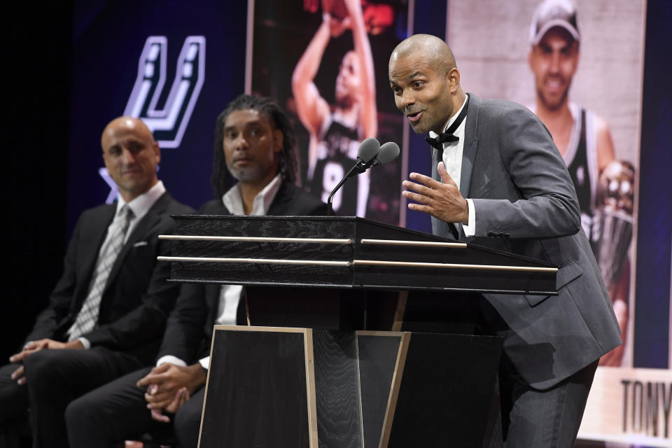 Tony Parker, right, speaks during his enshrinement at the Basketball Hall of Fame as presenters Manu Ginobili, left, and Tim Duncan, center, listen Saturday, Aug. 12, 2023, in Springfield, Mass. (AP Photo/Jessica Hill)