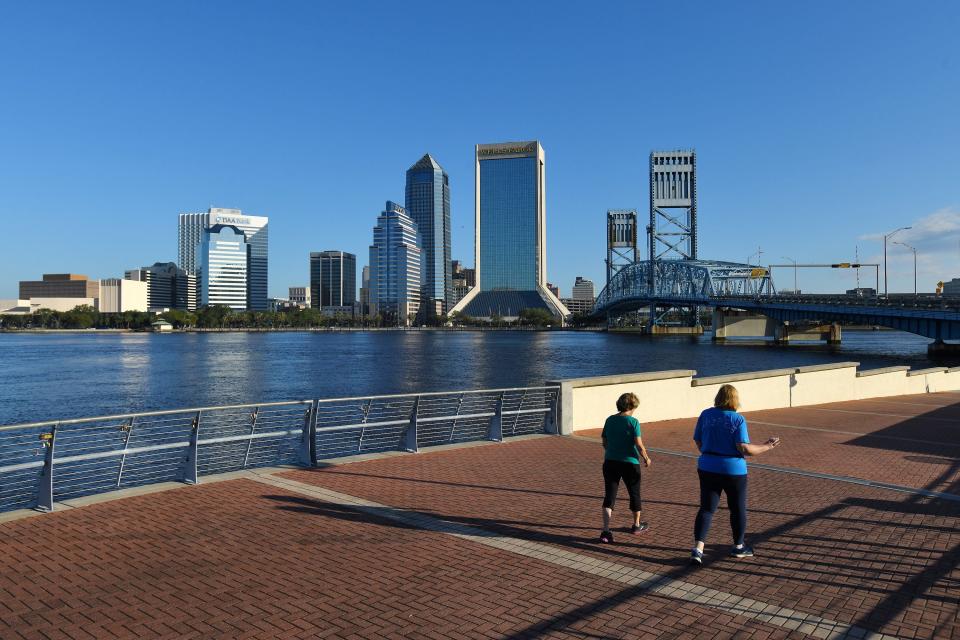 Two runners use the Southbank Riverwalk in 2021. The Southbank Riverwalk isn't as long as the one on the Northbank but Mayor Donna Deegan proposes an extension to the Fuller Warren Bridge in front of the Baptist Medical Center campus.