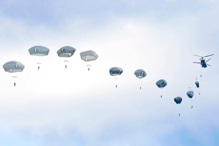 Army paratroopers jump from a CH-47 Chinook helicopter over the Bunker drop zone at Grafenwoehr Training Area, Germany, Aug. 14, 2019.