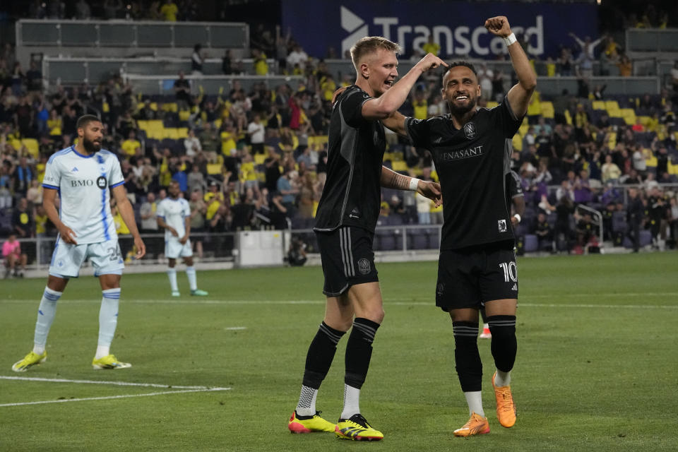 Nashville SC forward Sam Surridge, left, and midfielder Hany Mukhtar (10) celebrate a goal against CF Montréal during the second half of an MLS soccer match Saturday, May 4, 2024, in Nashville, Tenn. Nashville SC won 4-1. (AP Photo/George Walker IV)