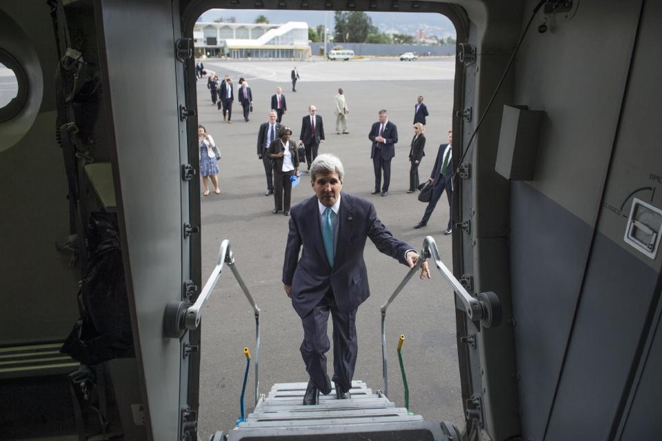 U.S. Secretary of State John Kerry, left, boards a U.S. Air Force C-17 military airplane prior to departure from Addis Ababa, Ethiopia, enroute to Juba, South Sudan, Friday, May 2, 2014. Kerry is urging South Sudan's warring government and rebel leaders to uphold a monthslong promise to embrace a cease-fire or risk the specter of genocide through continued ethnic killings. (AP Photo/Saul Loeb, Pool)