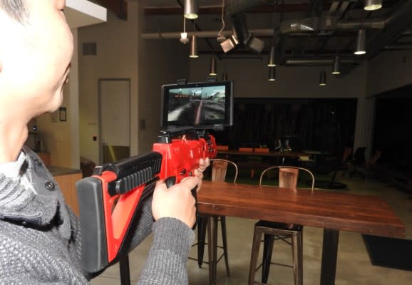 Larry Yang of Google demonstrates Project Tango's augmented reality shooter game.